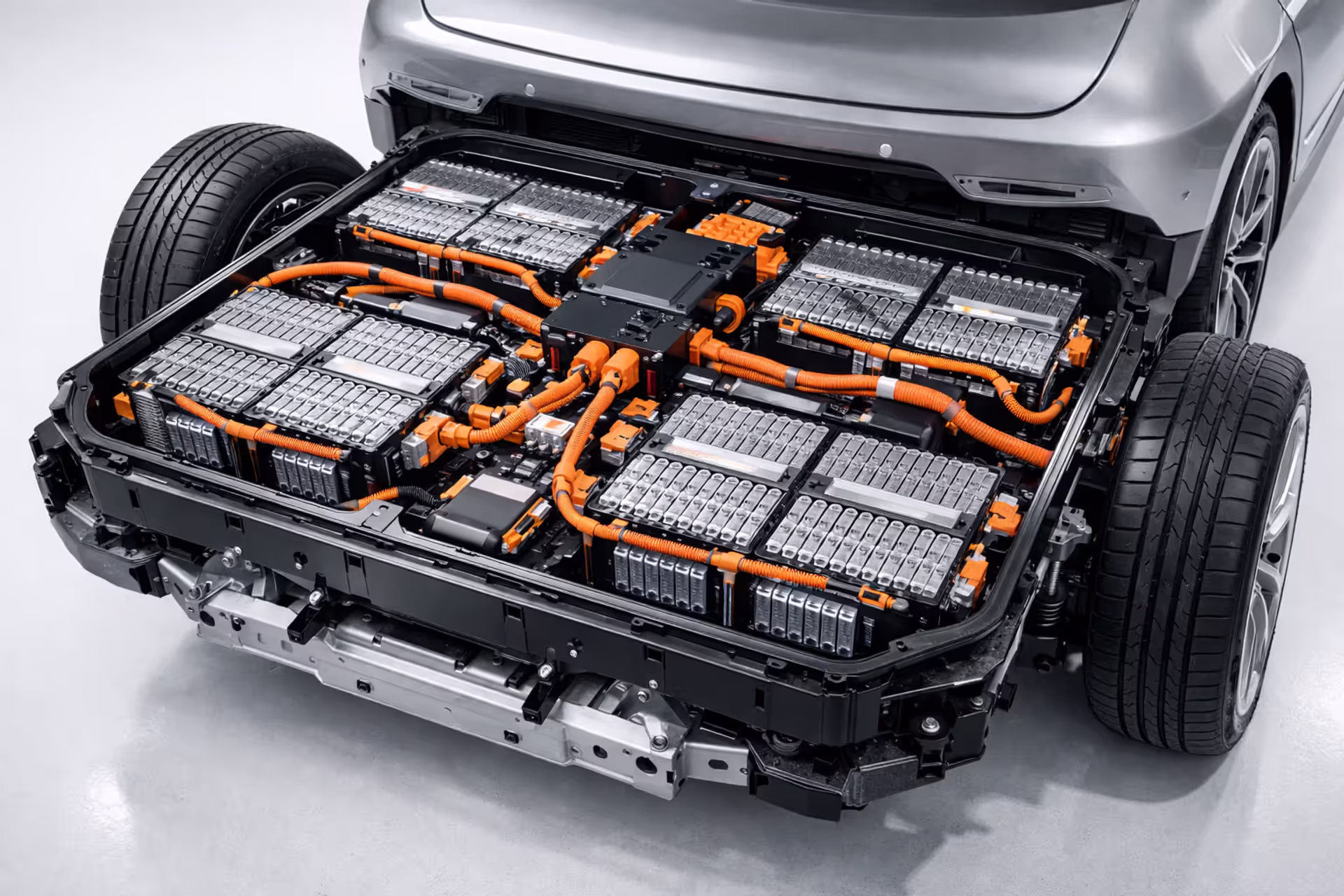 EV battery pack installed on electric vehicle chassis showing individual battery cells and high-voltage wiring
